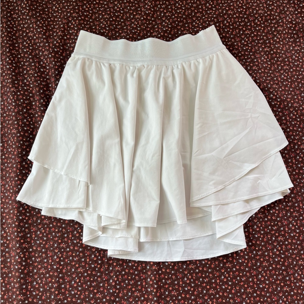 This is a Lululemon Women's Court Rival High Rise Tennis Skirt in white.